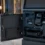 Industrial PC integrated inside modern self-service kiosk controlling printer scanner payment terminal and card dispenser, realistic kiosk deployment environment, professional industrial technology photography, blue-gray B2B style, no text, no watermark, 16:9